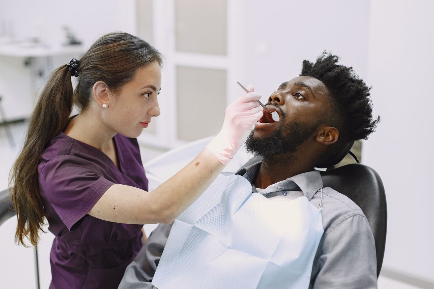 Dentist examining a patient in a dental chair