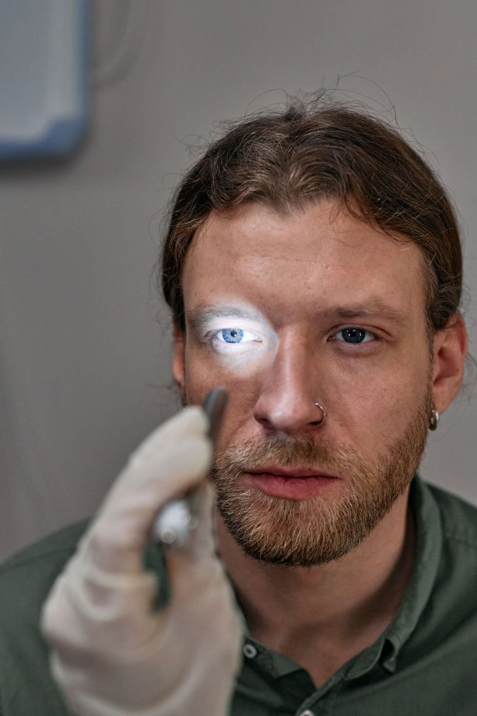 Doctor shining an examination light into a patient eye