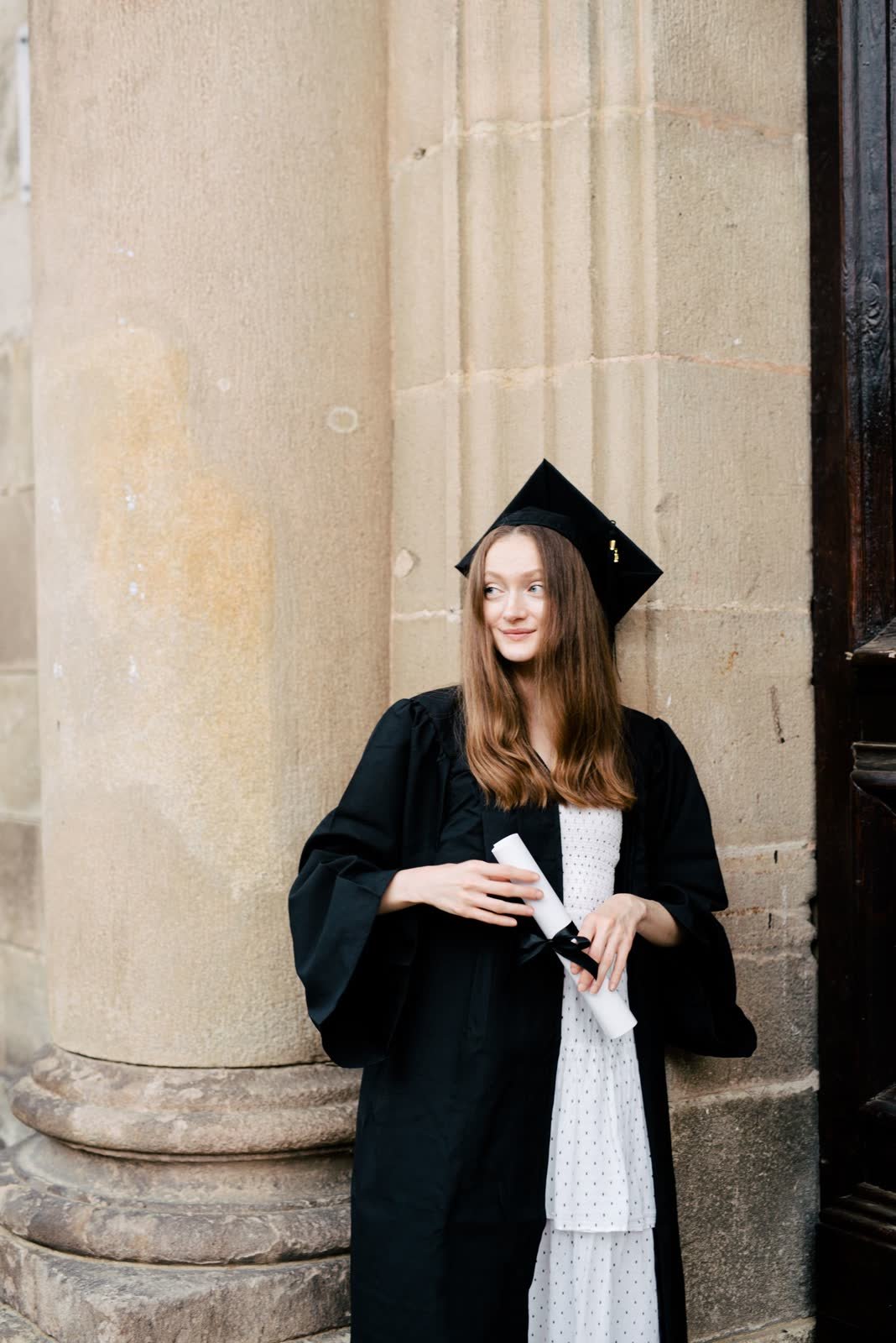 Graduate portrait by a stone column