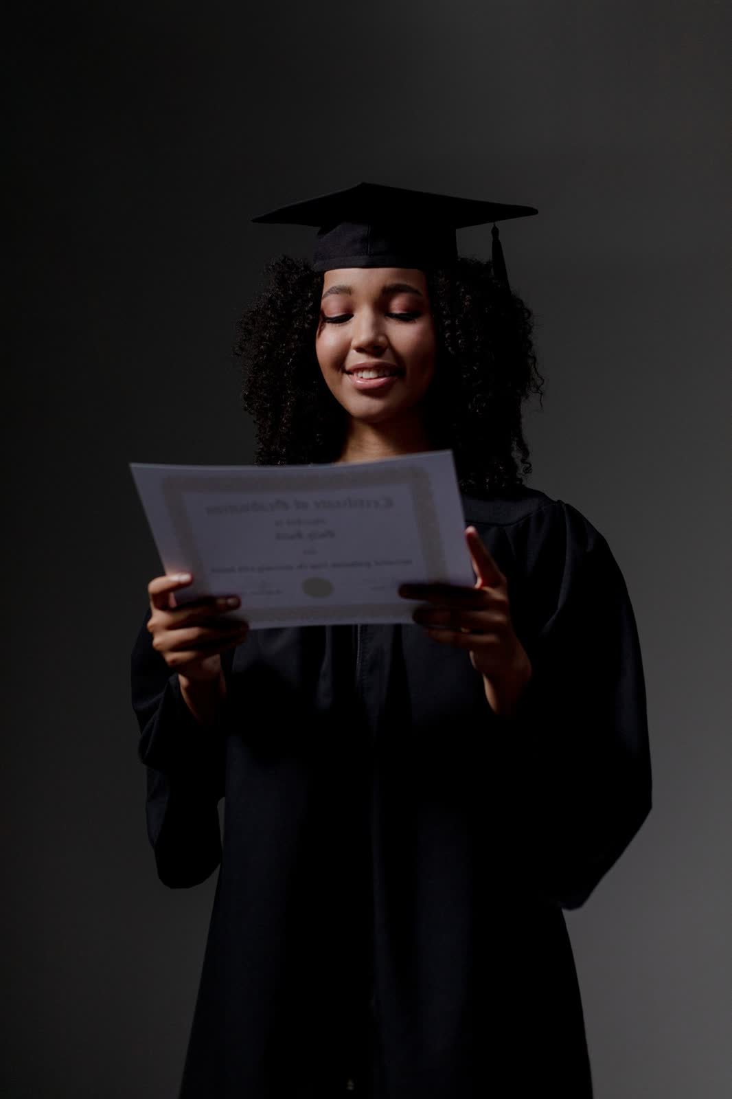 Graduate reading her diploma