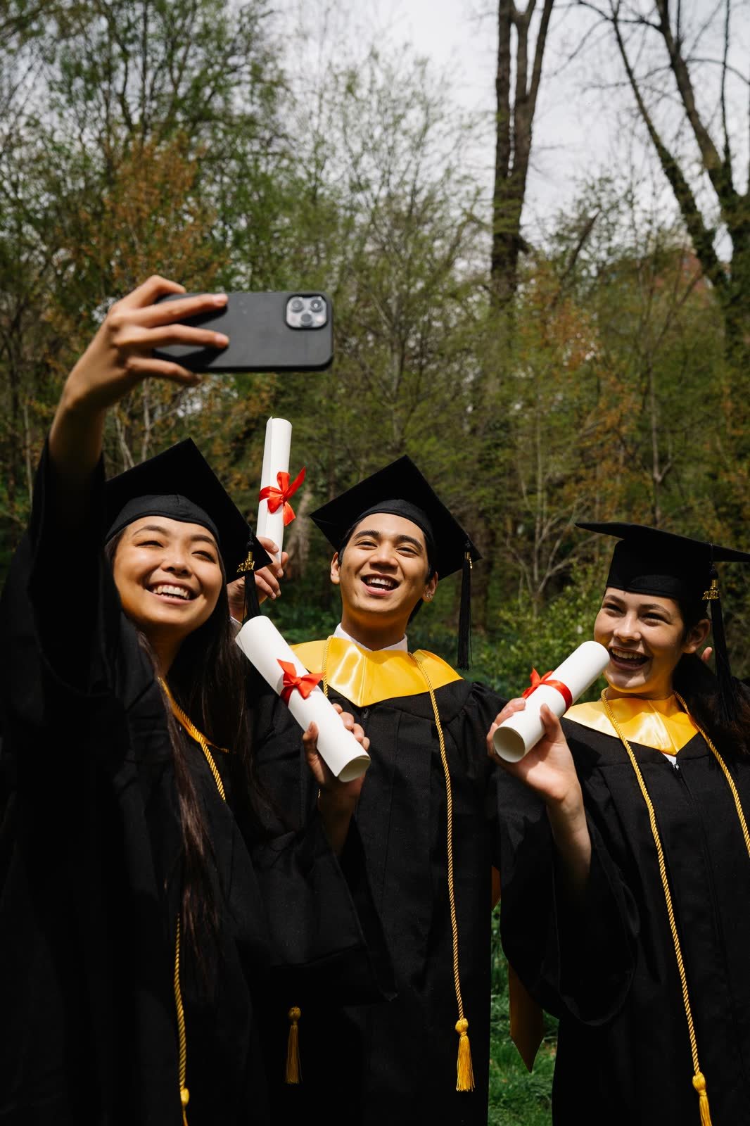 Graduates taking a selfie together