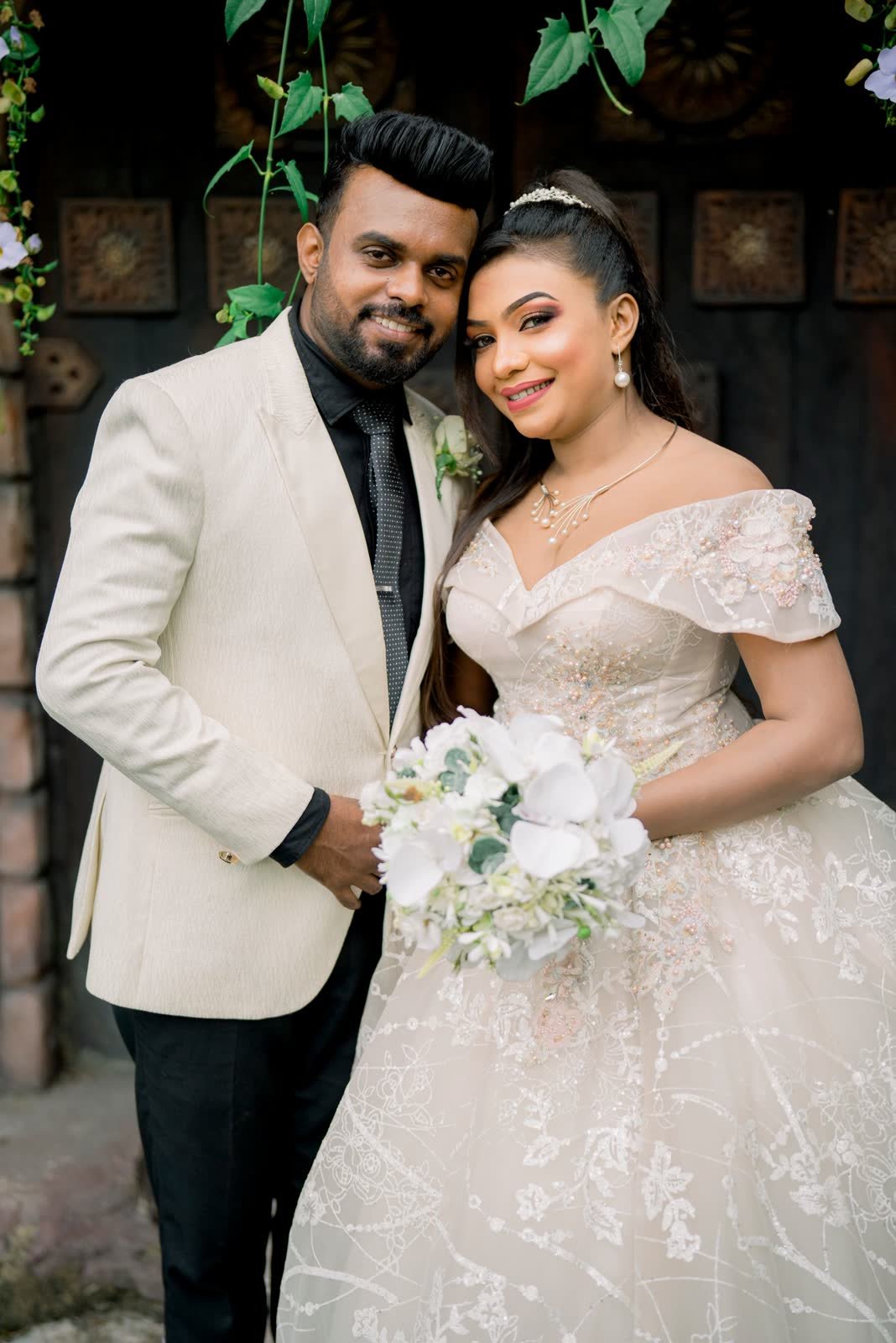 Bride and groom with the bouquet after the ceremony