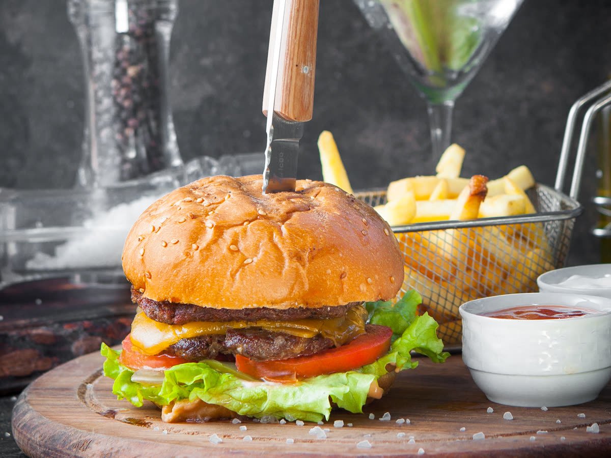 Burger and fries on a wooden board, food photography
