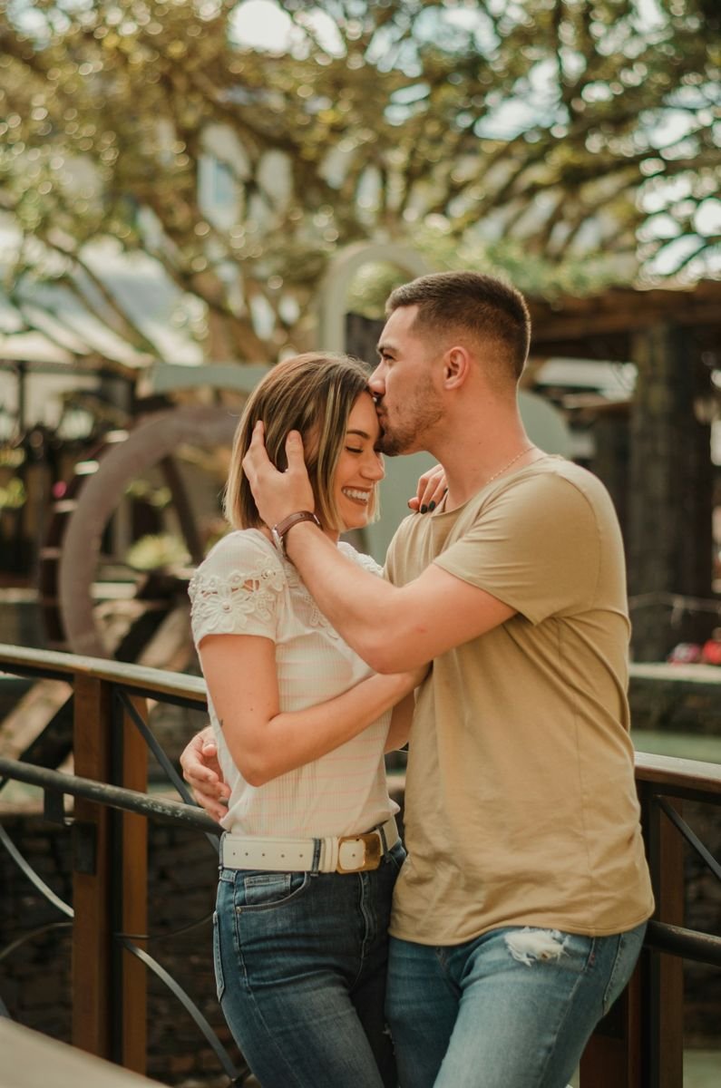 Couple embracing in a rustic outdoor setting