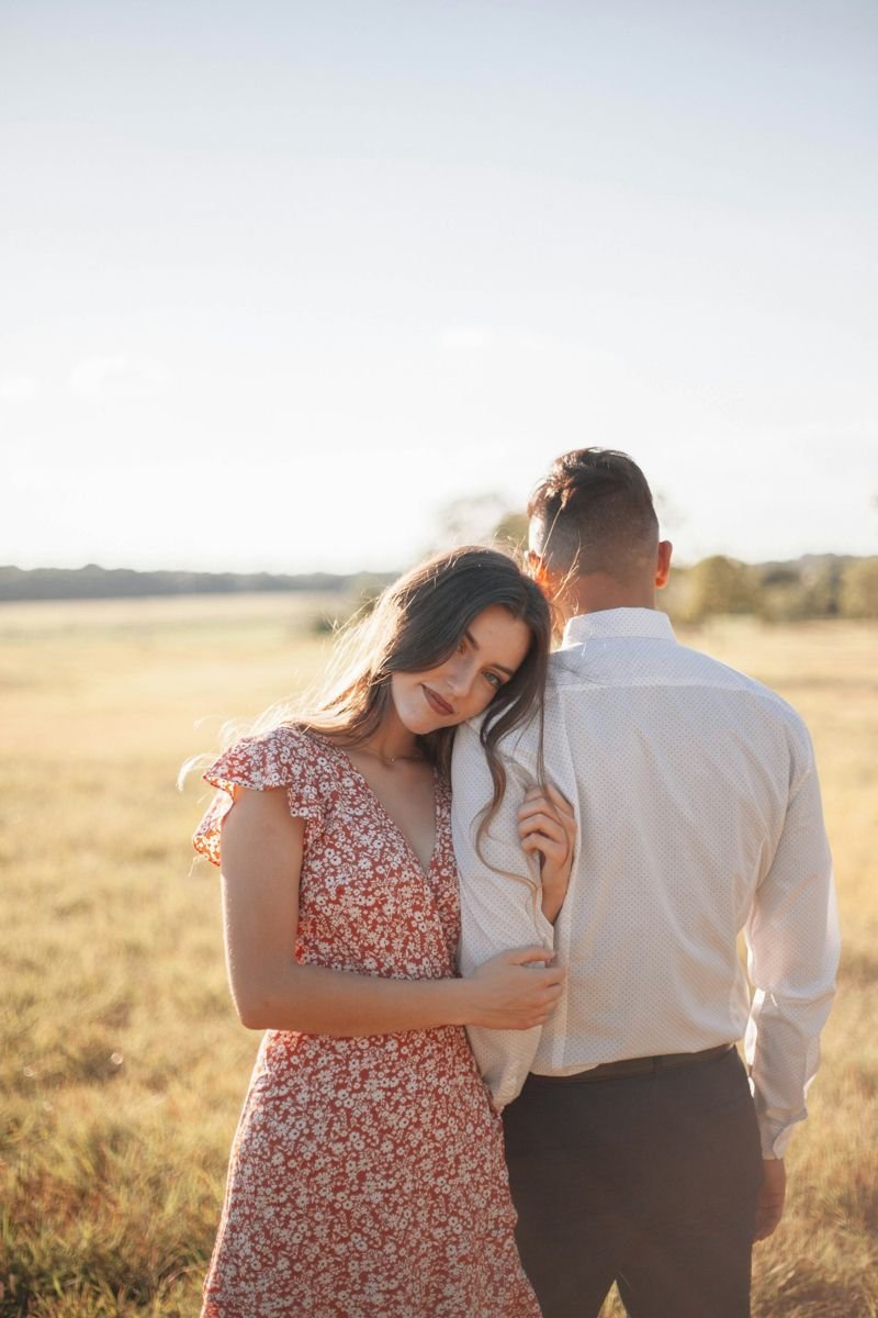 Engaged couple in a golden field