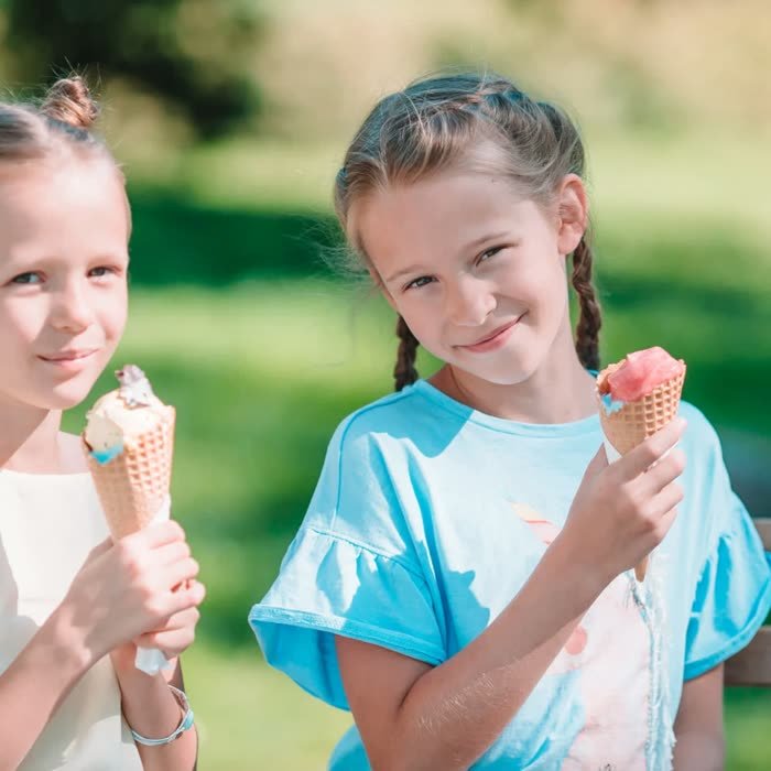 Sisters with ice cream in the park