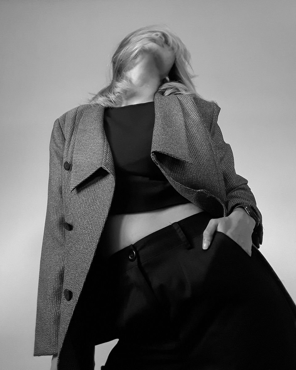 Black and white portrait of a model in a blazer