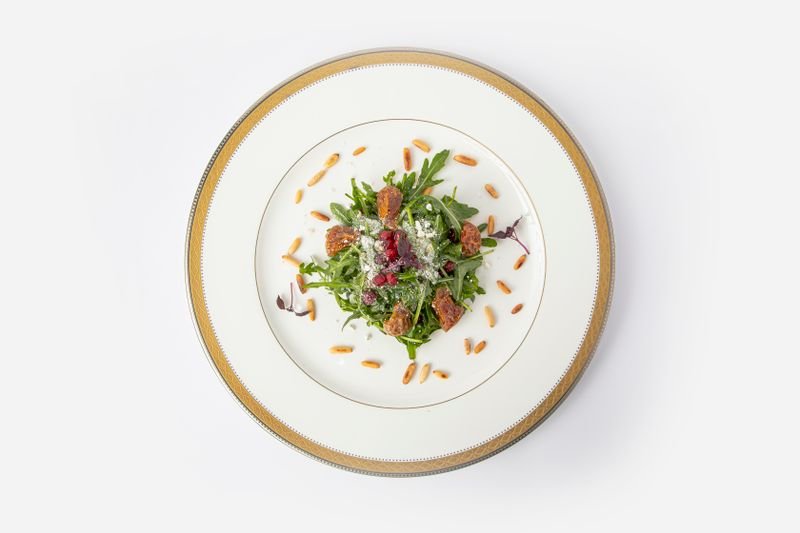 Plated salad photographed on a white background