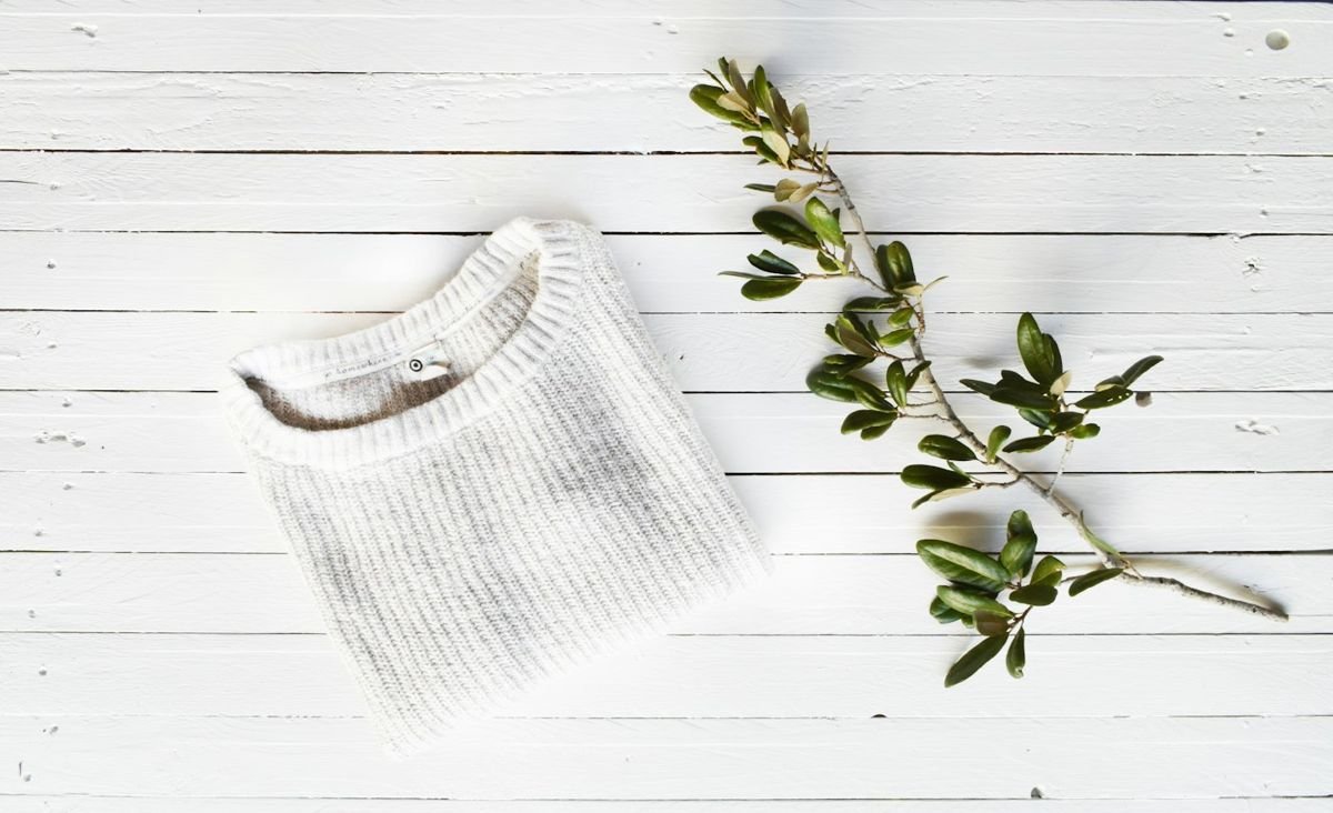 Knitwear flat lay on white wood