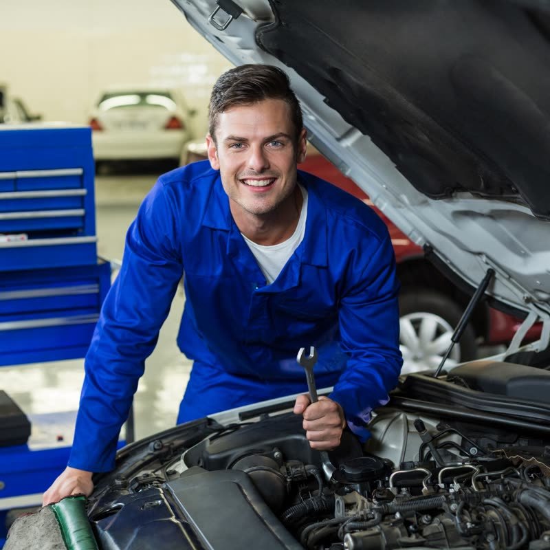 Mechanic working under a car hood