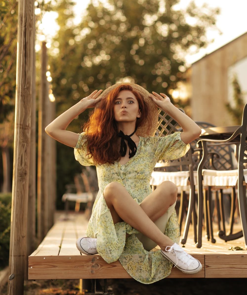 Woman in a straw hat at an outdoor portrait session